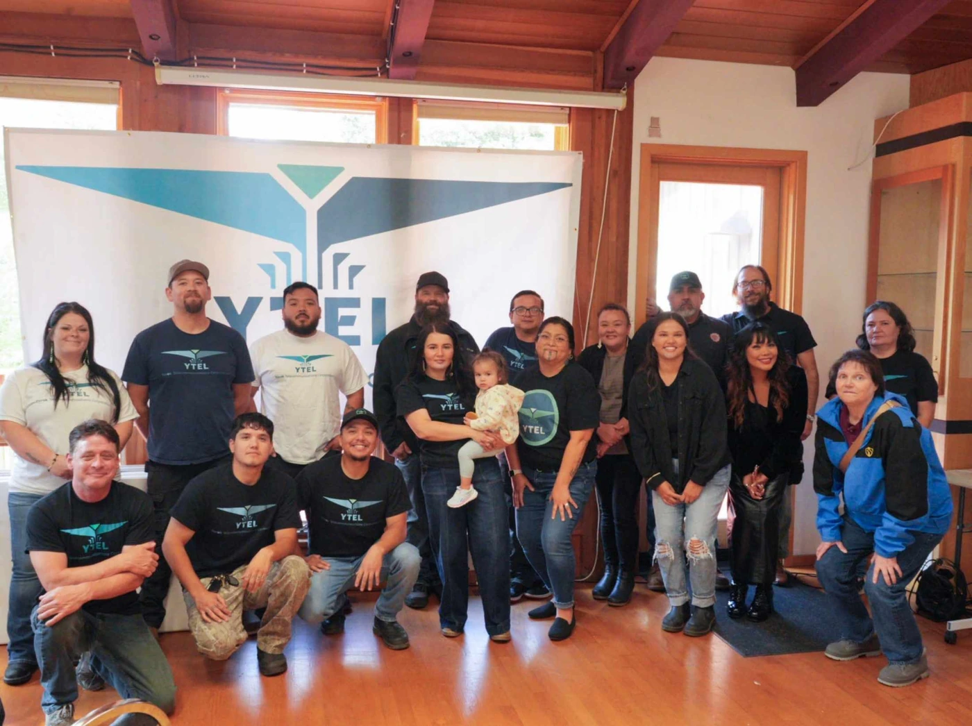 The Yurok Telecommunications team gathered together beneath their banner.